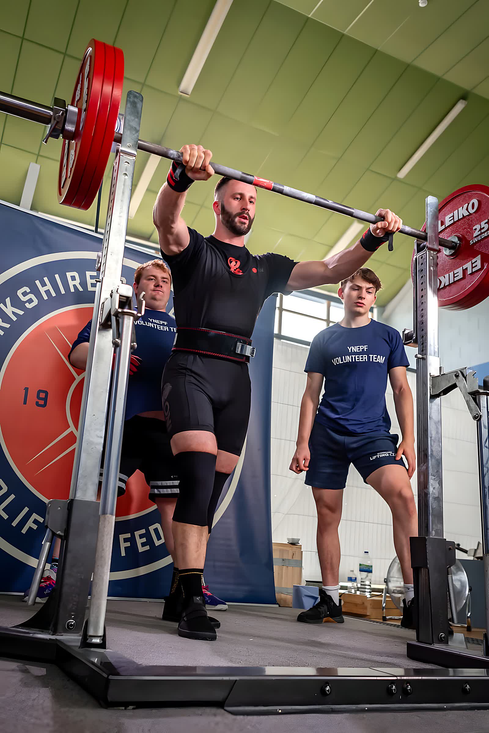 Adam Gucwa mid-lift at a powerlifting competition